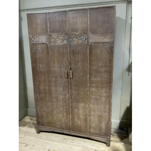 94 - A 1930s limed oak bedroom suite comprising two door wardrobe, compactum, single bed head and dressin... 