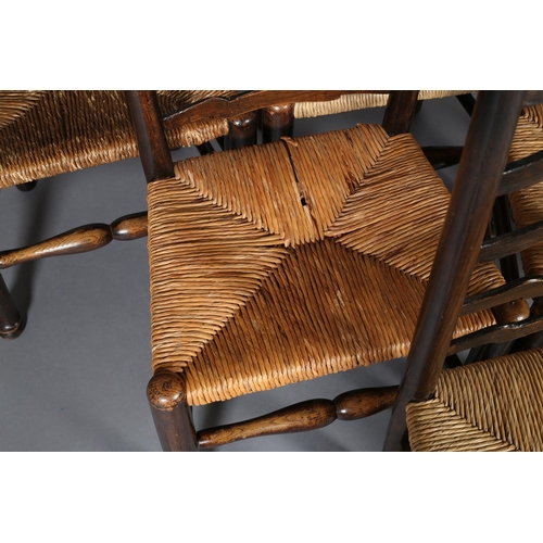 378 - A SET OF SIX 19TH CENTURY ELM WAVY LADDER BACK SINGLE CHAIRS, rush seated, on turned legs and front ... 