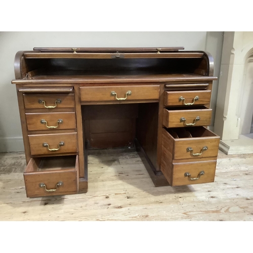 392 - An early 20th century mahogany tambour fronted desk having a drawer to the kneehole, each pedestal w... 