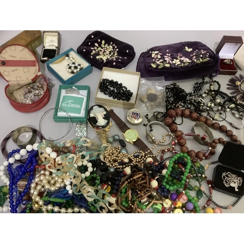 296 - A quantity of costume jewellery, mainly beads but also including brooches, bracelets, wristwatch etc... 