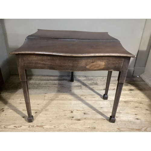 375 - A George II mahogany fold over tea table of serpentine outline having a fold over top and drawer to ... 