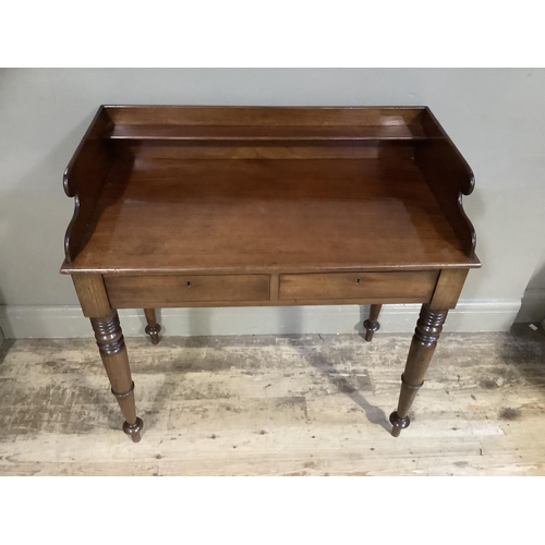 376 - A 19th century mahogany wash stand having a three-quarter gallery above two drawers to the apron and... 