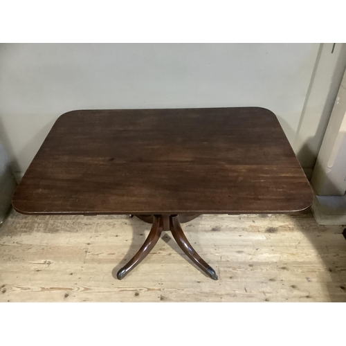 386 - A 19th century mahogany breakfast table having a rectangular tilt top, on turned pedestal and four d... 