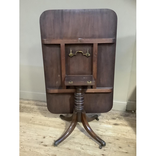 386 - A 19th century mahogany breakfast table having a rectangular tilt top, on turned pedestal and four d... 