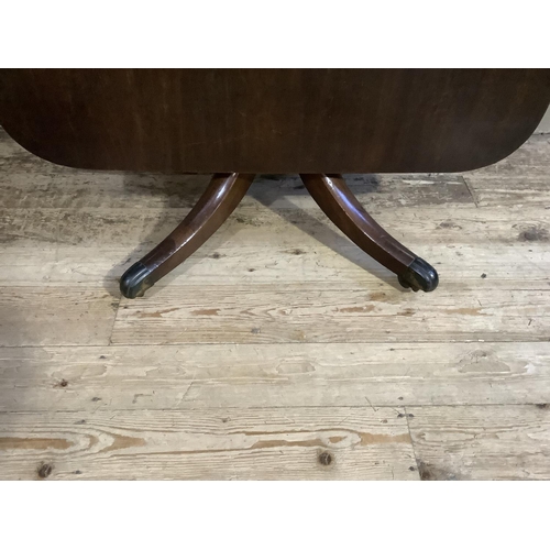 386 - A 19th century mahogany breakfast table having a rectangular tilt top, on turned pedestal and four d... 