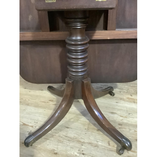 386 - A 19th century mahogany breakfast table having a rectangular tilt top, on turned pedestal and four d... 