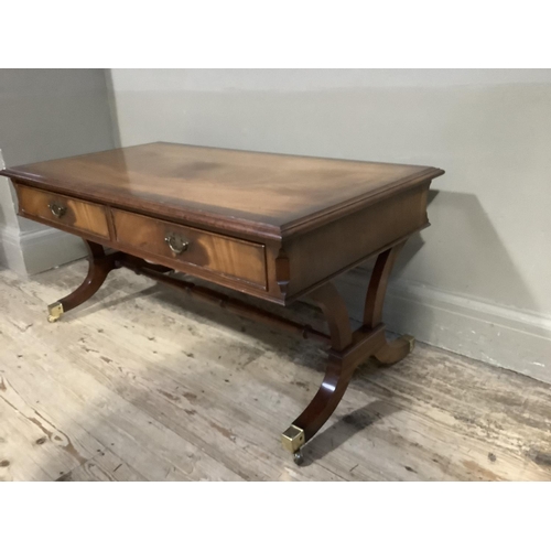 388 - A mahogany cross banded coffee table with two drawers and two dummy drawers to the apron, on refecto... 