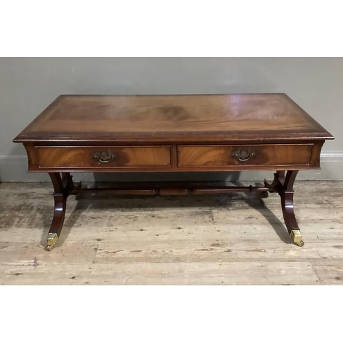 388 - A mahogany cross banded coffee table with two drawers and two dummy drawers to the apron, on refecto... 