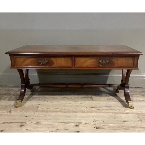 388 - A mahogany cross banded coffee table with two drawers and two dummy drawers to the apron, on refecto... 