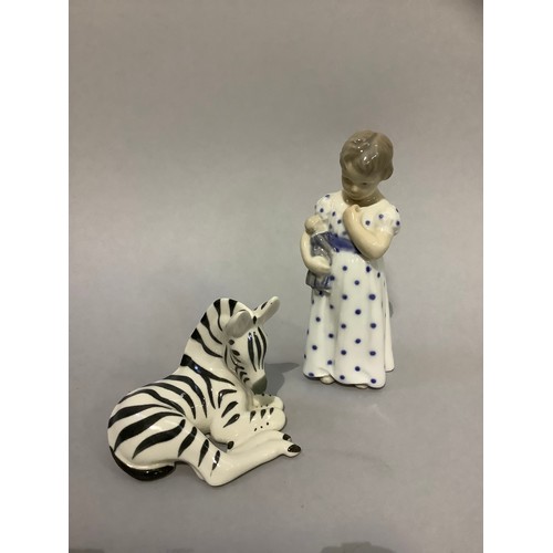 13 - A Royal Copenhagen figure of a girl with teddy bear and a USSR china figure of a zebra