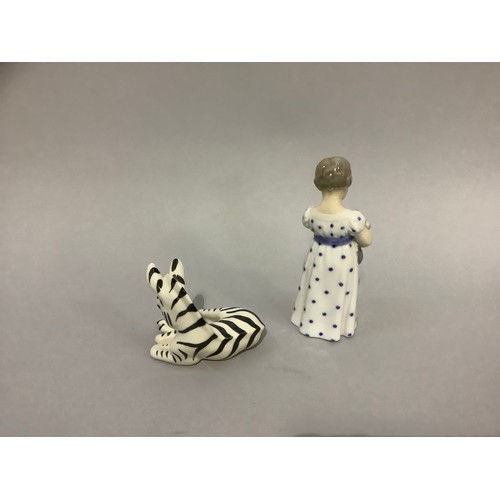 13 - A Royal Copenhagen figure of a girl with teddy bear and a USSR china figure of a zebra