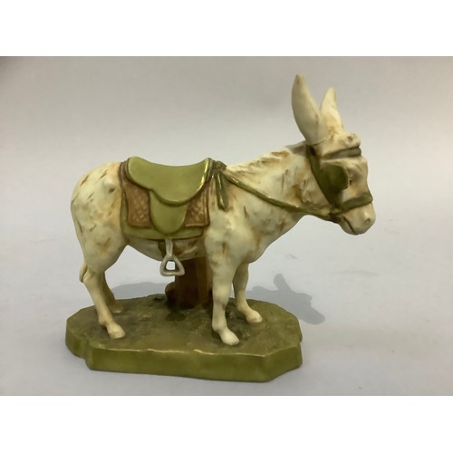 43 - A Royal Dux Bohemia figure of a donkey wearing a saddle, on naturalistic base, pink triangular pad m... 
