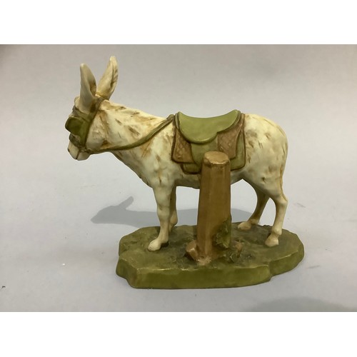 43 - A Royal Dux Bohemia figure of a donkey wearing a saddle, on naturalistic base, pink triangular pad m... 