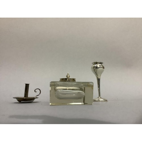 216 - A silver lidded glass ink well of rectangular form with pen rest, 6cm by 7.5cm together with a minia... 