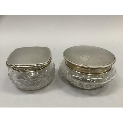 263 - Two cut glass pin jars with silver tops, Sheffield 1940 and Birmingham 1958