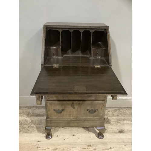 338 - A lady's walnut bureau having a fall front fitted interior with small drawers and pigeon holes above... 