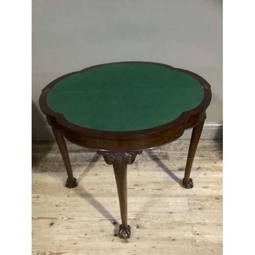 385B - A mahogany card table of scalloped outline having a fold over top lined in baise and on three cabrio... 