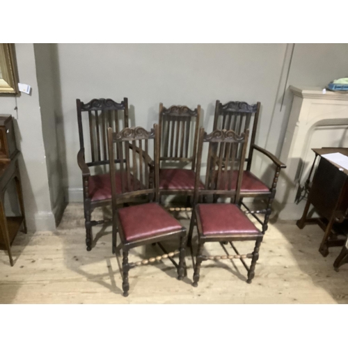 389 - A set of five 1920s oak dining chairs having a carved top rail above slatted back, drop in seats and... 