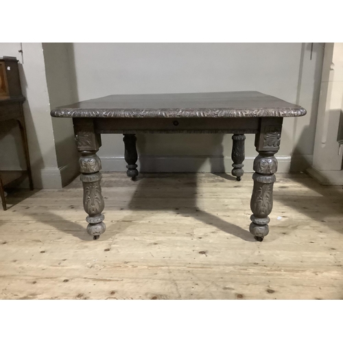 390 - A Victorian dark oak extending dining table with leaf and winder, carved edge and legs, 124cm long, ... 