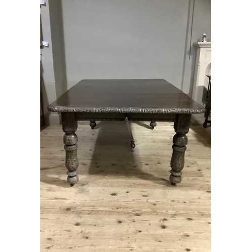 390 - A Victorian dark oak extending dining table with leaf and winder, carved edge and legs, 124cm long, ... 