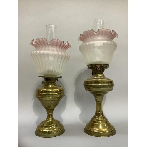 188 - Two brass oil lamps with pink tinted and opaque glass shades