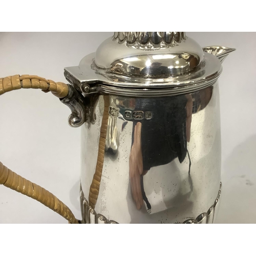 220 - A Victorian silver hot water jug, reeded base and lid with acorn finial and wicker covered handle, h... 