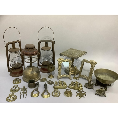59 - Three hurricane lamps and a quantity of brass ware