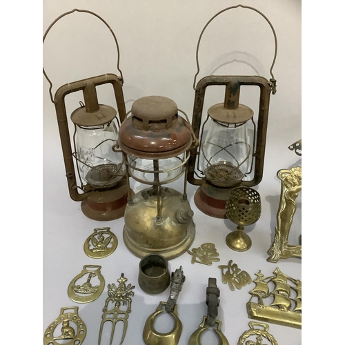 59 - Three hurricane lamps and a quantity of brass ware