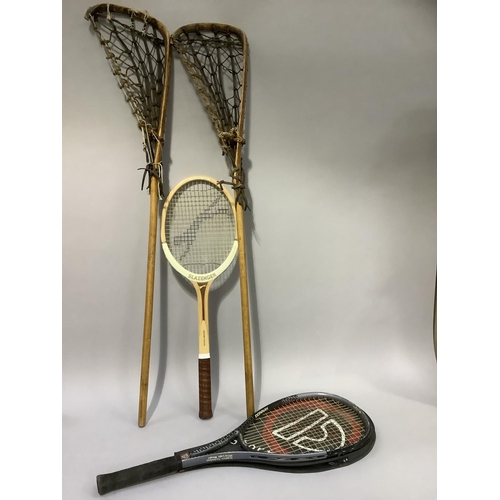 73 - A pair of lacrosse sticks and two tennis rackets