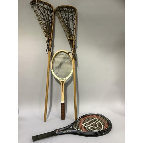 73 - A pair of lacrosse sticks and two tennis rackets