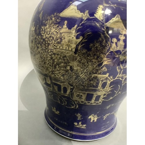 62 - A 19th century Chinese vase of baluster form, blue glaze, painted in gilt with a pagoda river island... 