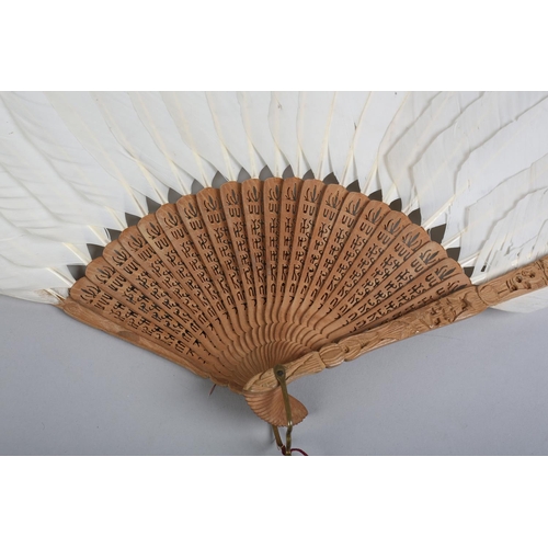 141 - Two 19th century Chinese white duck or goose feather fans, the first mounted on carved wood, the gor... 