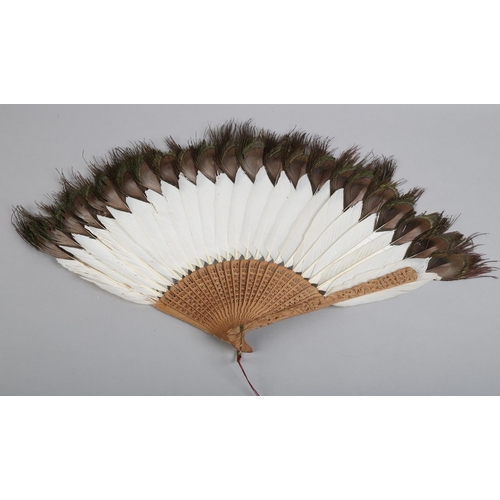 141 - Two 19th century Chinese white duck or goose feather fans, the first mounted on carved wood, the gor... 