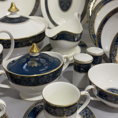 28 - An extensive Royal Doulton dinner, tea and coffee service of Carlyle pattern comprising 22 dinner pl... 