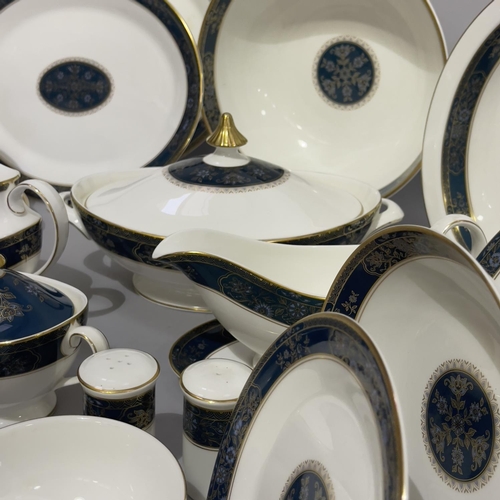 28 - An extensive Royal Doulton dinner, tea and coffee service of Carlyle pattern comprising 22 dinner pl... 