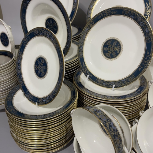 28 - An extensive Royal Doulton dinner, tea and coffee service of Carlyle pattern comprising 22 dinner pl... 