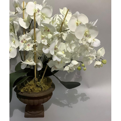 29 - A faux orchid held in an urn on square base, approximately 70cm high