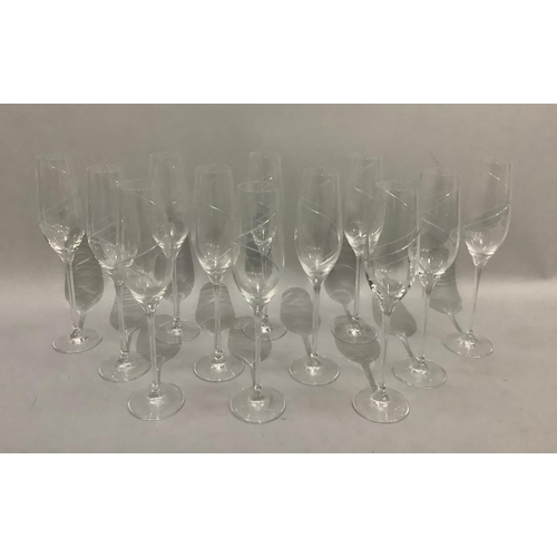 37 - A set of twelve Royal Doulton crystal champagne glasses, cut and edged with a entwined ribbon design