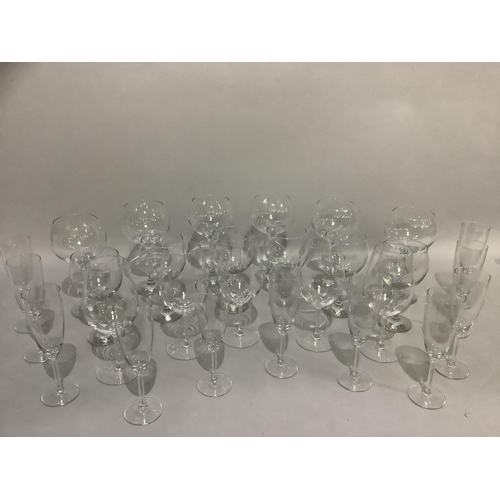 41 - A selection of plain table glass including a set of twelve champagne coups, six cocktail glasses, el... 