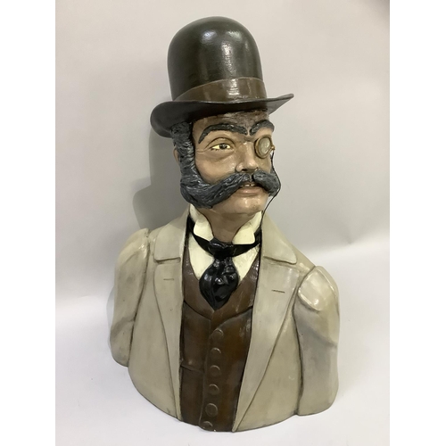 59 - A head and shoulder bust of a Phileas Fogg with bowler hat, monocle and handle bar moustache, cravat... 