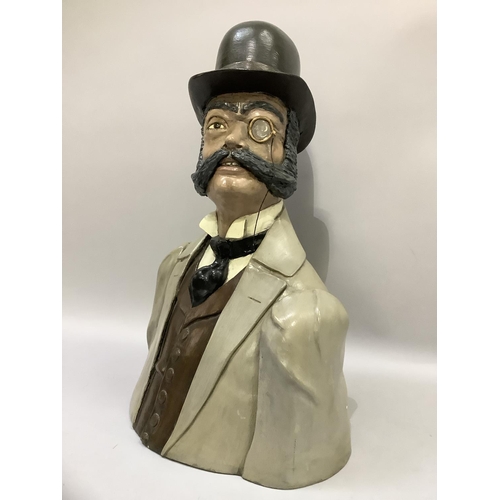 59 - A head and shoulder bust of a Phileas Fogg with bowler hat, monocle and handle bar moustache, cravat... 