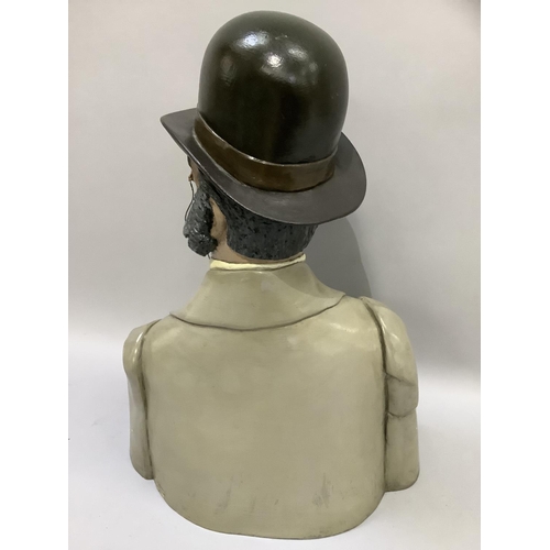 59 - A head and shoulder bust of a Phileas Fogg with bowler hat, monocle and handle bar moustache, cravat... 