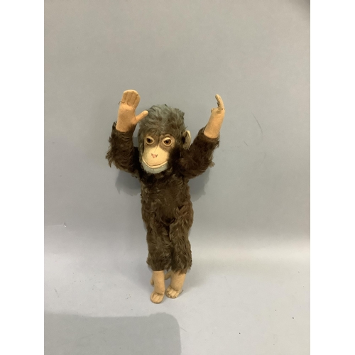 101 - A Steiff monkey with brown fur and pink felt face, ears and paws, with jointed limbs, the label worn... 