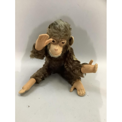 101 - A Steiff monkey with brown fur and pink felt face, ears and paws, with jointed limbs, the label worn... 