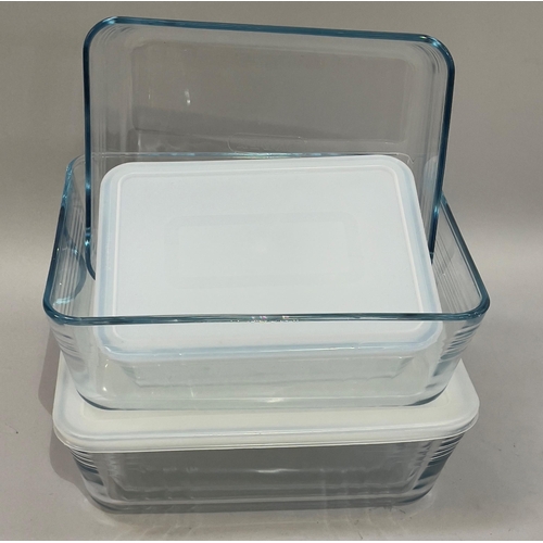 118 - A quantity of glass Pyrex dishes with plastic tops, graduated sets of three rectangular, two smaller... 