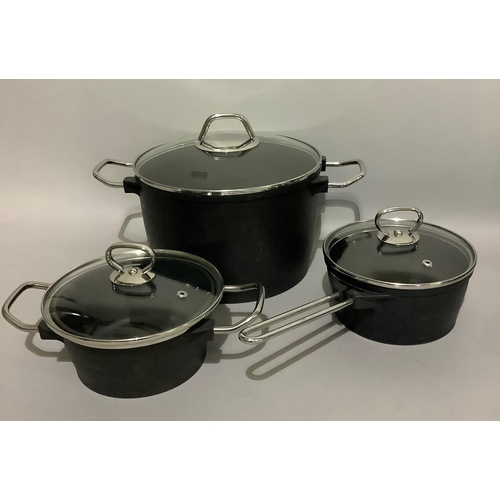 151 - A set of Fissler cast iron cookware including a two-handled cast iron casserole with domed glass lid... 