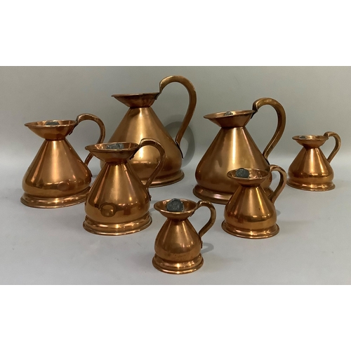 89 - A set of seven copper jugs of graduated size from half-gallon, quart, pint, half-pint, one gill, hal... 