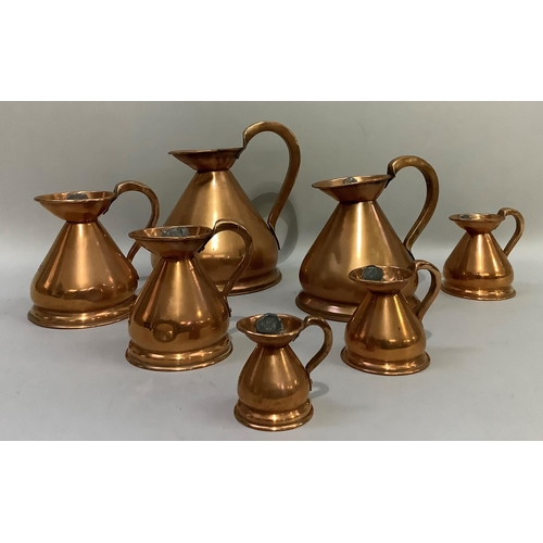 89 - A set of seven copper jugs of graduated size from half-gallon, quart, pint, half-pint, one gill, hal... 