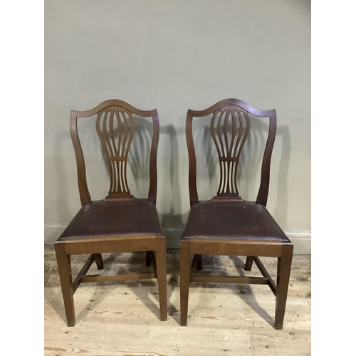 166 - A pair of early 20th century Hepplewhite design mahogany single chairs with rexine seats, on square ... 