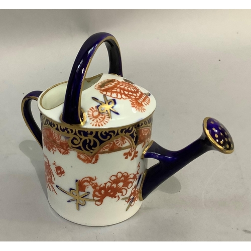 187 - A Royal Crown Derby miniature watering can together with various pill boxes in metal and pottery, tw... 